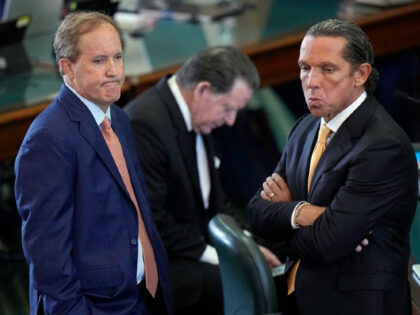 Texas state Attorney General Ken Paxton, left, stands with his attorney Tony Buzbee, right