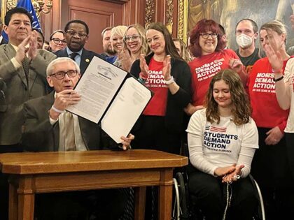 Wisconsin Gov. Tony Evers prepares to sign an executive order, Tuesday, Jan. 14, 2025, in