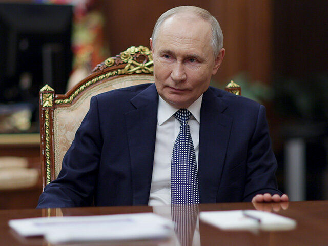 Russian President Vladimir Putin listens to President of the National Medical Research Cen