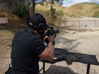 Rabbi Raziel Cohen, aka "Tactical Rabbi", shoots an AR-15 style semi-automatic r