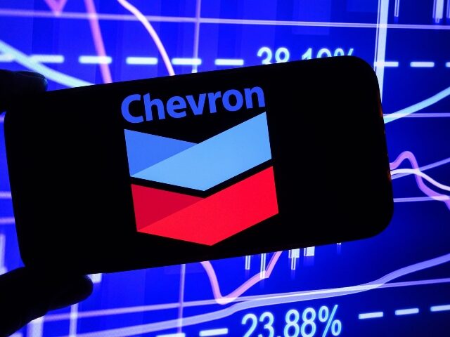 In this photo illustration, the Chevron company logo is seen displayed on a smartphone scr