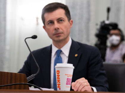 Secretary of Transportation Pete Buttigieg testifies with a Dunkin Donuts beverage during