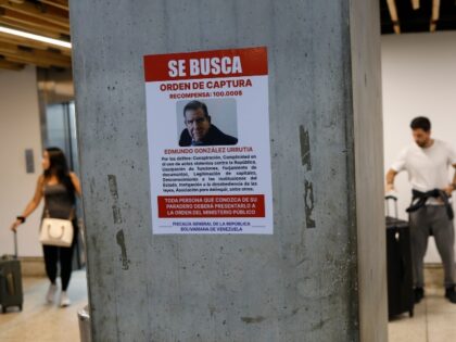 A wanted poster of Venezuela's opposition leader Edmundo Gonzalez covers a column at