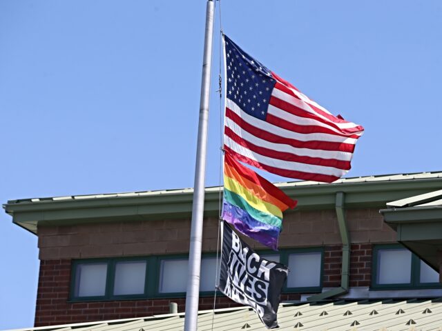 Worcester, MA - July 19: The US flag, the rainbow pride flag and a Black Lives Matter flag