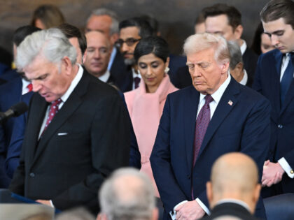 US President-elect Donald Trump (C) bows his head as US evangelist president of Samaritan&