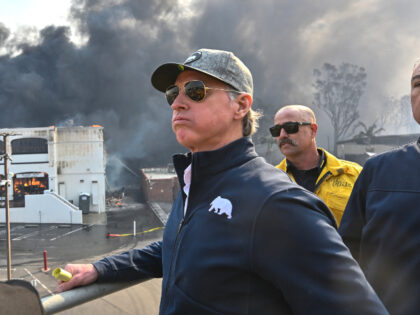 California Governor Gavin Newsom, left, surveys damage in Pacific Palisades with CalFire&#