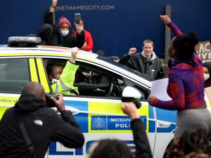 LONDON, UNITED KINGDOM - JUNE 06: A police officer raises his fist outside his car window