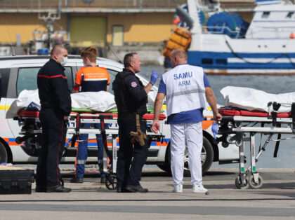 TOPSHOT - Firefighters, a police officer and a doctor of the SAMU emergency unit stand nex