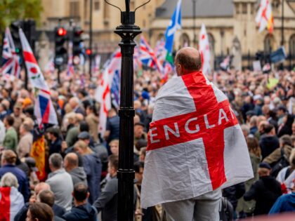 LONDON, UNITED KINGDOM - 2024/10/26: A protestors wrapped with the cross of England takes