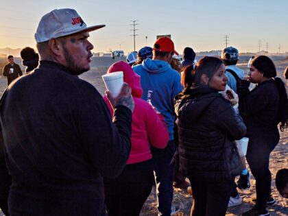 Migrants along the US-Mexico border in Juarez, Chihuahua state, Mexico, on Wednesday, Dec.