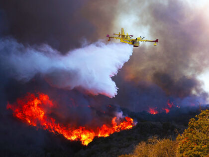 A firefighting plane makes a drop on the Palisades fire in Pacific Palisades on Tuesday, J