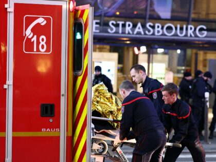 Firefighters carry an injured person on a strechter outside the Strasbourg railway station