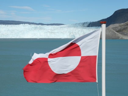 EQIP SERMIA, GREENLAND - JULY 31: A Greenlandic flag flies near the Eqip Sermia glacier, a