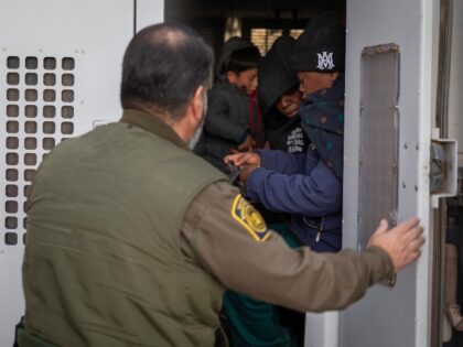 SASABE, ARIZONA - JANUARY 20: Immigrants prepare to be transported by the U.S. Border Patr