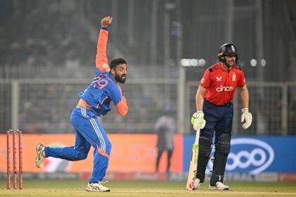 India's Varun Chakravarthy (L) took three wickets, including the crucial scalp of Jos Butt