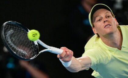 Italy's Jannik Sinner hits a return against Australia's Alex De Minaur