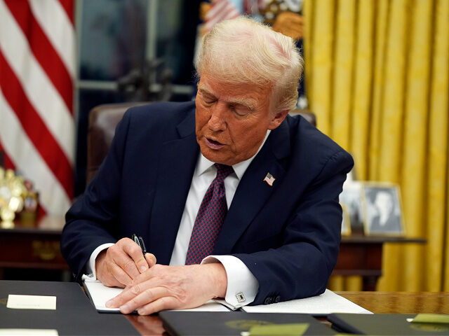 President Donald Trump signs executive orders in the Oval Office of the White House, Monda