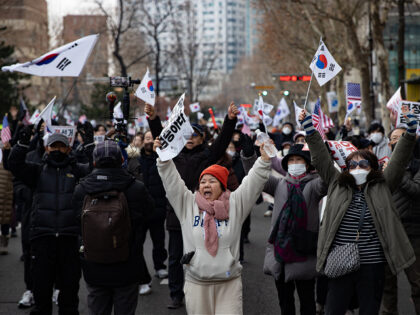 Supporters of President Yoon Suk-yeol, who is detained on charges of treason, march toward