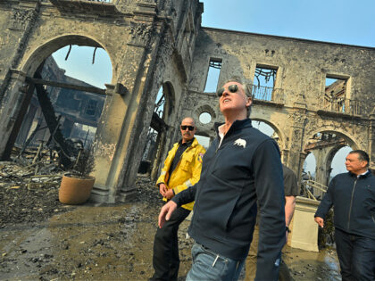 PCIFIC PALISADES, CA - January 08: California Governor Gavin Newsom, center, surveys damag