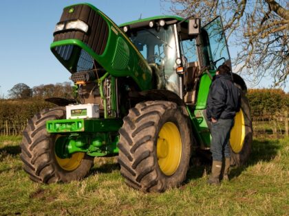 John Deere tractor with bonnet up in field.