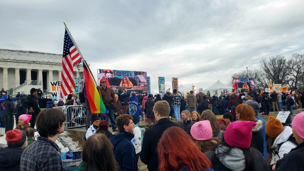 The U.S. flag flies upside down, a symbol of distress, atop an LGTBQ+ flag. (Lana Shadwick/Breitbart Texas)