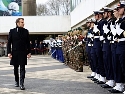 Emmanuel Macron reviews the troops during a military ceremony while visiting the Digital S