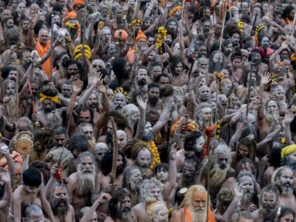 Hindu pilgrims arrive to take a holy dip in the sacred waters of Sangam, the confluence of