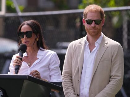 Meghan Markle, left, speaks next to her husband Prince Harry, right, during, the Giant of