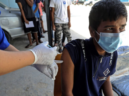 llegal migrants receive a Covid-19 vaccine at the Airport Road Shelter Centre in Libya&#03