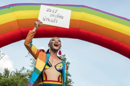 A member of the LGBTQ community celebrates after the Thai parliament passed the final sena