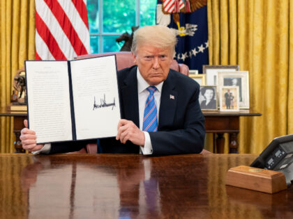 President Donald J. Trump displays his signature after signing an Executive Order on Prote