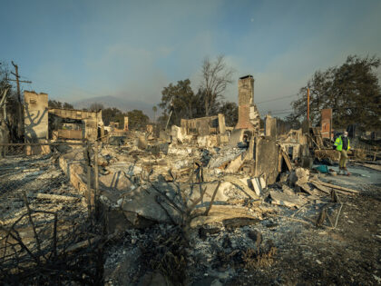 Altadena, CA - January 09: George Cunningham, walks through the rubble of the house he and