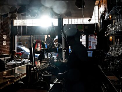 A worker cleans glasses at Le Central restaurant in San Francisco, California, US, on Tues