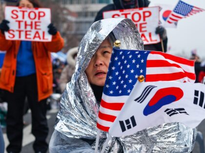 SEOUL, SOUTH KOREA - JANUARY 6: People holding American and South Korean flags take part i