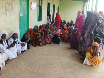 Sudanese wait outside a hospital for medical check-up in Tokar in the Read Sea State follo