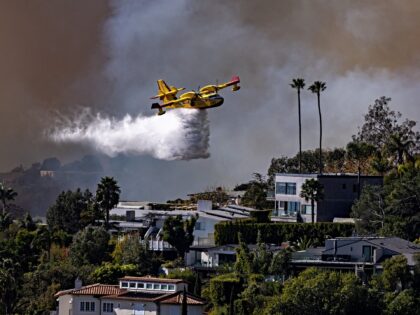 Pacific Palisades, CA - January 07: A Super Scooper drops ocean water on a hillside as the