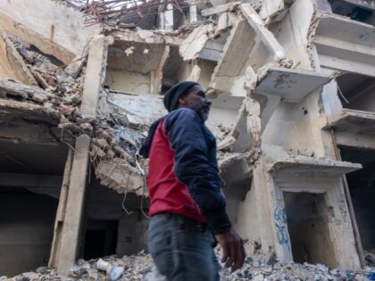 DAMASCUS, SYRIA - JANUARY 19: Residents walk through the streets of the Yarmouk Palestinia