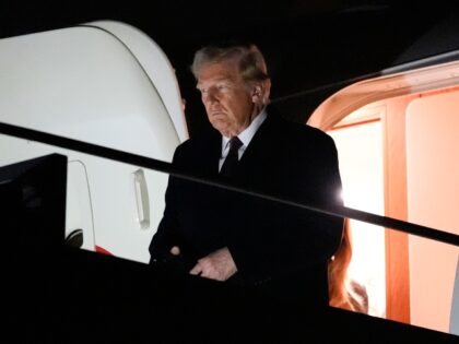 President-elect Donald Trump walks off an Air Force Special Mission airplane as he arrives