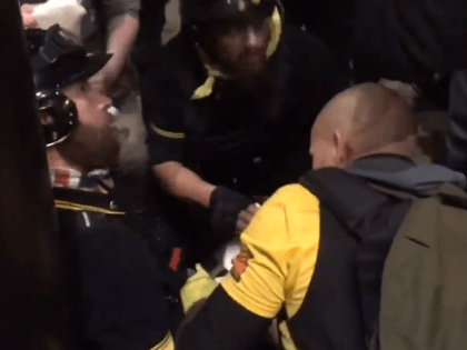 Proud Boys tend to stabbing victim during DC protest. (Twitter Video Screenshot/@elaadelia